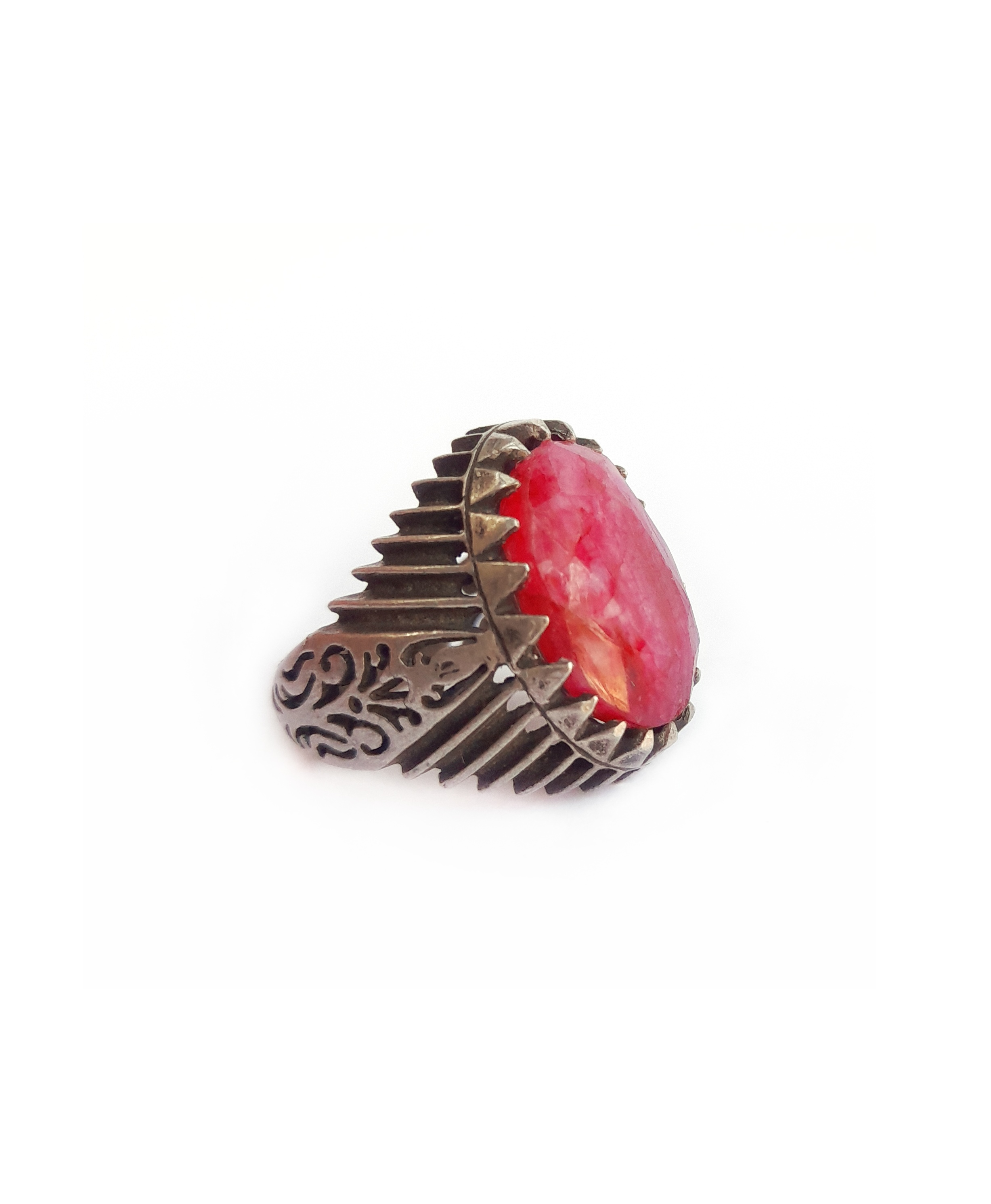Ethnic silver and ruby root statement ring. Its silver setting shows exquisite Afghan silver work and the ruby root gem is of a beautiful purple/pink color, shiny and faceted, which reflects the light in a lovely way.