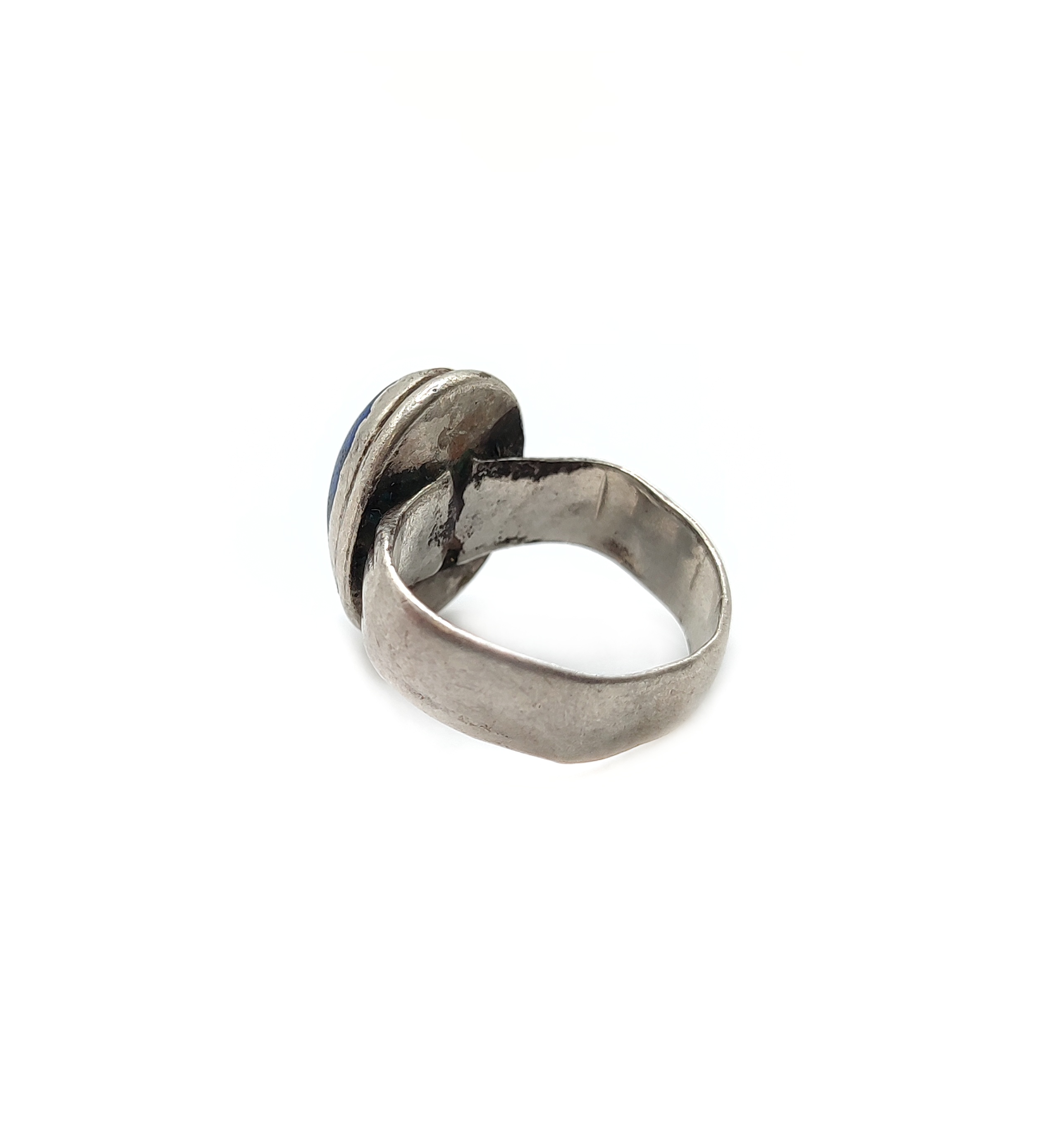 Very old silver ring with blue stone. This silver ring from Afghanistan is visibly very old and worn, and carries a blue stone, most likely lapis lazuli but might have been color enhanced. It is nonetheless a beautiful old silver ring, antique ethnic jewelry piece from Central Asia.